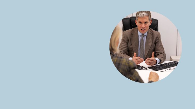 A photograph of Dr James Wilson, private oncologist in London, talking to a patient about private cancer treatment